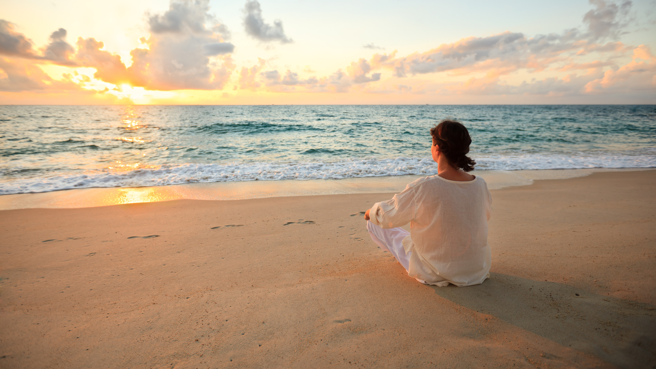 woman at sunrise at the beach